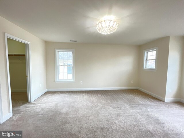 7212 Highland St, Springfield, VA 22150 - unfurnished bedroom with carpet floors, a spacious closet, a chandelier, and a closet