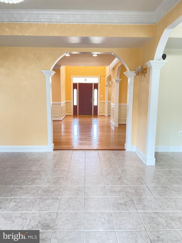 7212 Highland St, Springfield, VA 22150 - entryway with ornate columns, light tile patterned flooring, crown molding, arched walkways, and a decorative wall