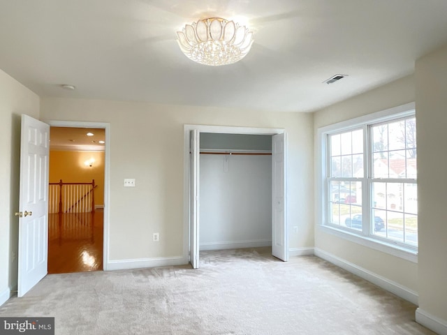 7212 Highland St, Springfield, VA 22150 - unfurnished bedroom with light carpet, a chandelier, and a closet