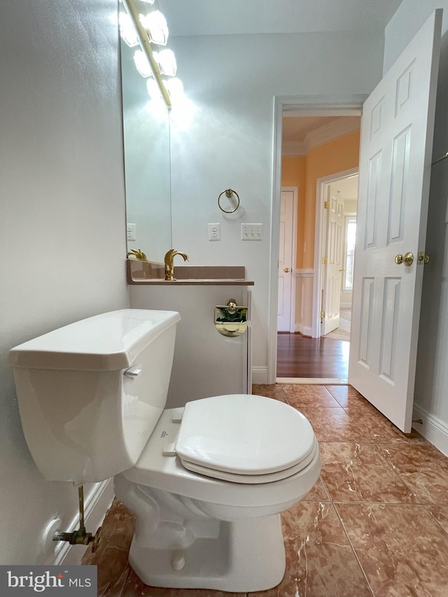 7212 Highland St, Springfield, VA 22150 - bathroom with toilet and crown molding