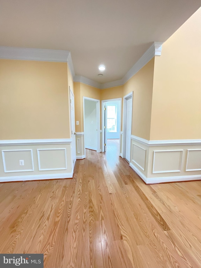 7212 Highland St, Springfield, VA 22150 - empty room with ornamental molding, light wood-style floors, a decorative wall, and a wainscoted wall