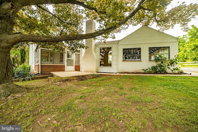 4117 Chichester Ave, Upper Chichester, PA 19061 - view of front of home with a chimney, a front yard, and a patio