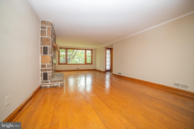 4117 Chichester Ave, Upper Chichester, PA 19061 - unfurnished living room with crown molding, light wood-style floors, and a stone fireplace