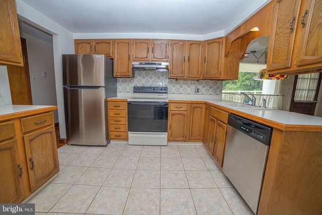 4117 Chichester Ave, Upper Chichester, PA 19061 - kitchen with appliances with stainless steel finishes, exhaust hood, brown cabinetry, and light countertops