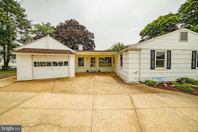 4117 Chichester Ave, Upper Chichester, PA 19061 - ranch-style house with concrete driveway, a garage, and a chimney