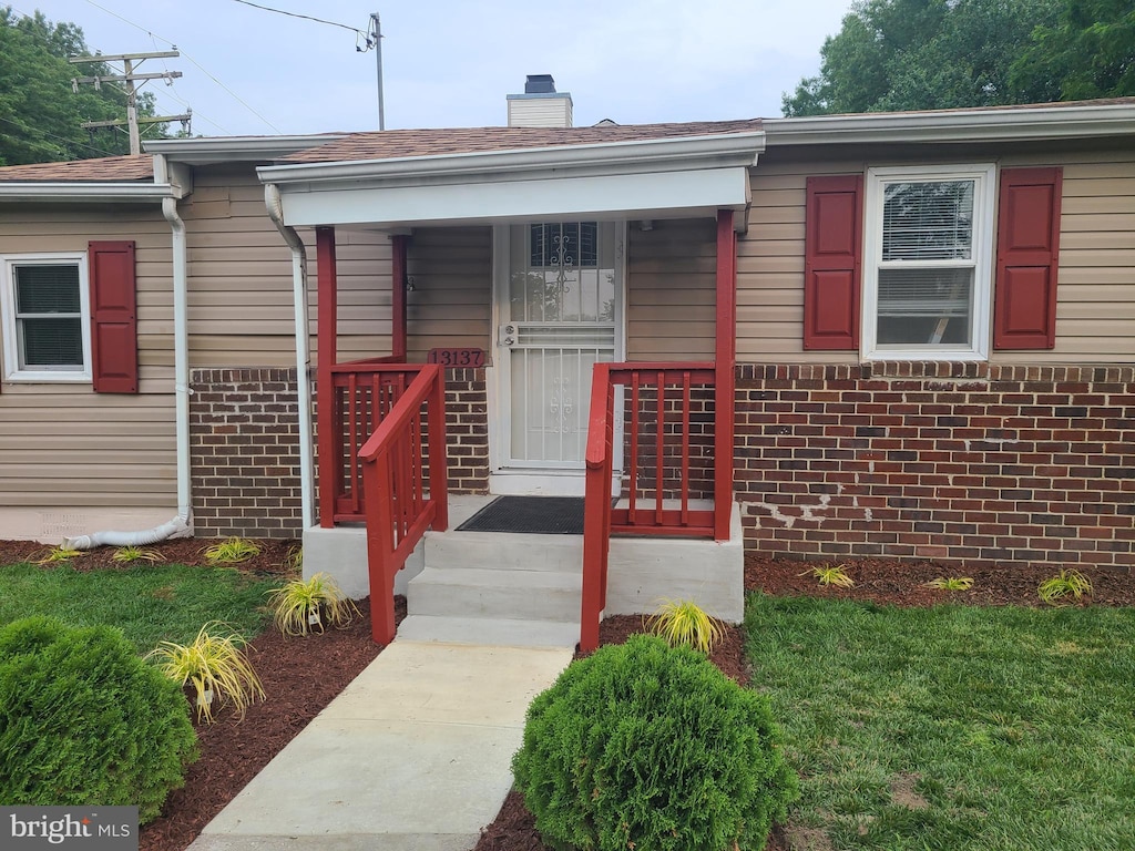 13137 12th St, Bowie, MD 20715 - view of front of house featuring brick siding, a porch, and a chimney