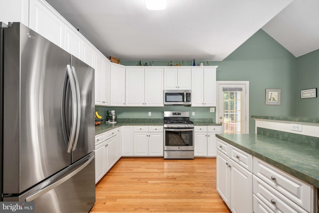4 Monument Dr, Stafford, VA 22554 - kitchen featuring appliances with stainless steel finishes, dark countertops, white cabinets, and lofted ceiling