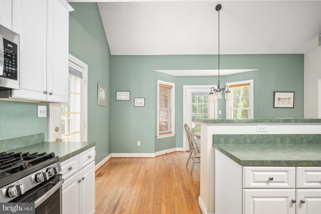 4 Monument Dr, Stafford, VA 22554 - kitchen featuring dark countertops, stainless steel microwave, a chandelier, lofted ceiling, and light wood-style floors