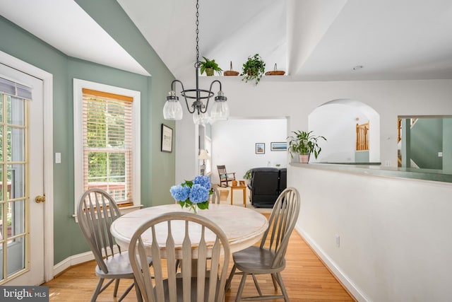 4 Monument Dr, Stafford, VA 22554 - dining area featuring light wood finished floors, vaulted ceiling, and arched walkways