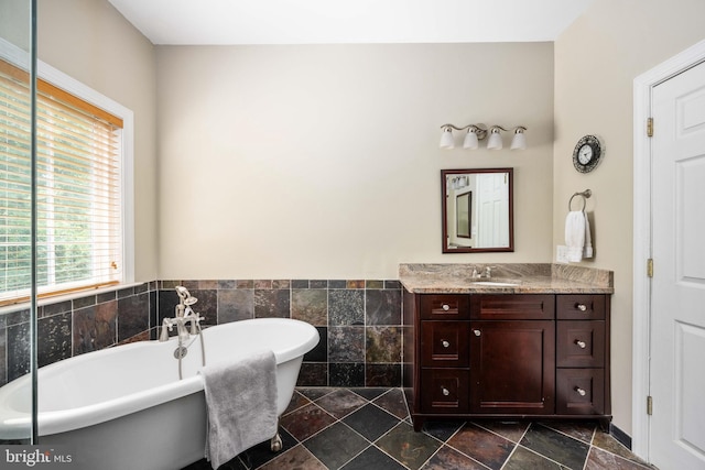 4 Monument Dr, Stafford, VA 22554 - bathroom featuring vanity, a freestanding bath, tile walls, and wainscoting