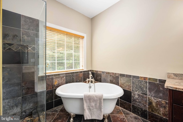 4 Monument Dr, Stafford, VA 22554 - bathroom with tile walls, a freestanding bath, tiled shower, vanity, and wainscoting