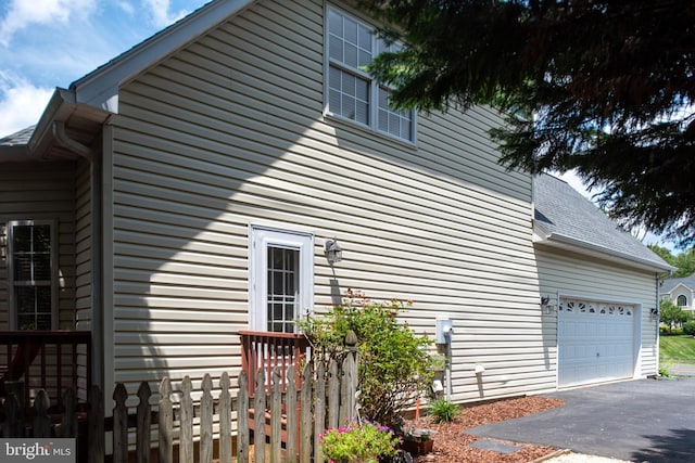 4 Monument Dr, Stafford, VA 22554 - view of side of property featuring asphalt driveway, an attached garage, and a shingled roof