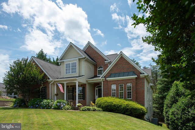 4 Monument Dr, Stafford, VA 22554 - view of front of property with a front yard, brick siding, and covered porch