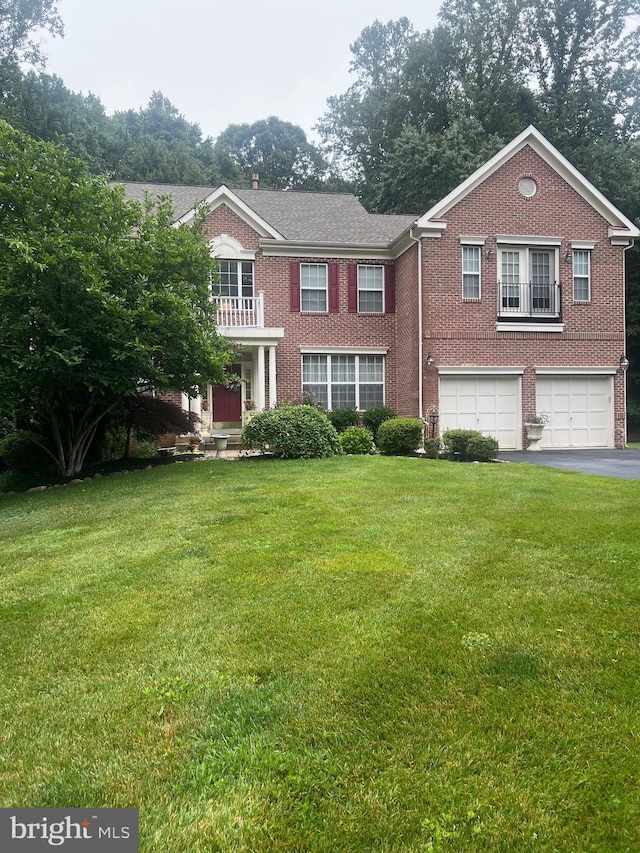 6194 Treywood Ln, Manassas, VA 20112 - colonial-style house with brick siding, driveway, a garage, and a front lawn