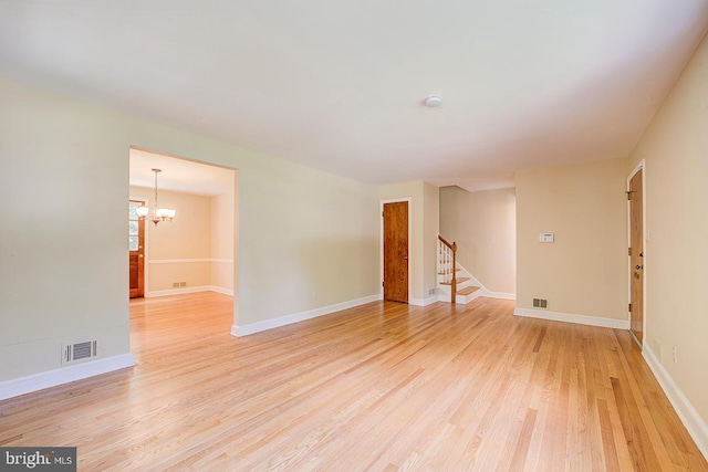 6717 44th Ave, Hyattsville, MD 20782 - unfurnished room featuring light wood-style flooring, stairway, a chandelier, and a smoke detector