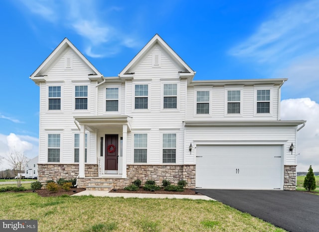 10137 Premier St, Fredericksburg, VA 22408 - view of front of home featuring stone siding, asphalt driveway, a garage, and a front yard