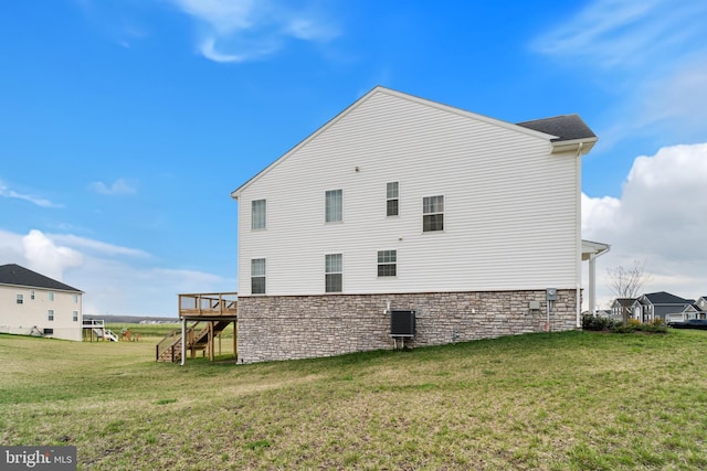 10137 Premier St, Fredericksburg, VA 22408 - view of home's exterior with stairway, stone siding, a deck, and a lawn