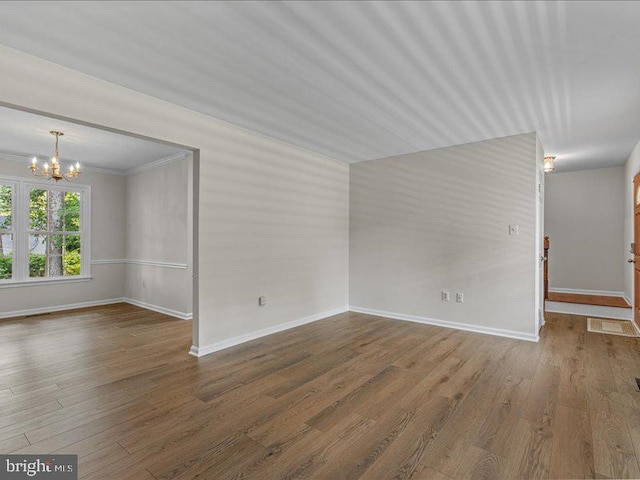 900 Young Dairy Ct, Herndon, VA 20170 - unfurnished room featuring a chandelier, wood finished floors, and ornamental molding