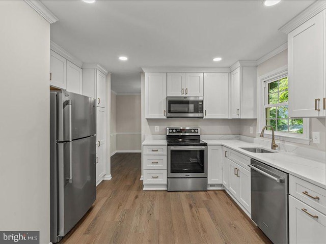 900 Young Dairy Ct, Herndon, VA 20170 - kitchen featuring stainless steel appliances, white cabinetry, light countertops, ornamental molding, and recessed lighting