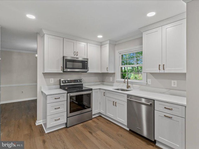 900 Young Dairy Ct, Herndon, VA 20170 - kitchen with stainless steel appliances, crown molding, white cabinetry, dark wood finished floors, and recessed lighting