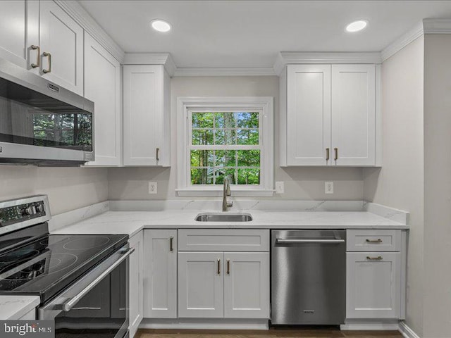 900 Young Dairy Ct, Herndon, VA 20170 - kitchen featuring stainless steel appliances, white cabinets, light stone counters, crown molding, and recessed lighting