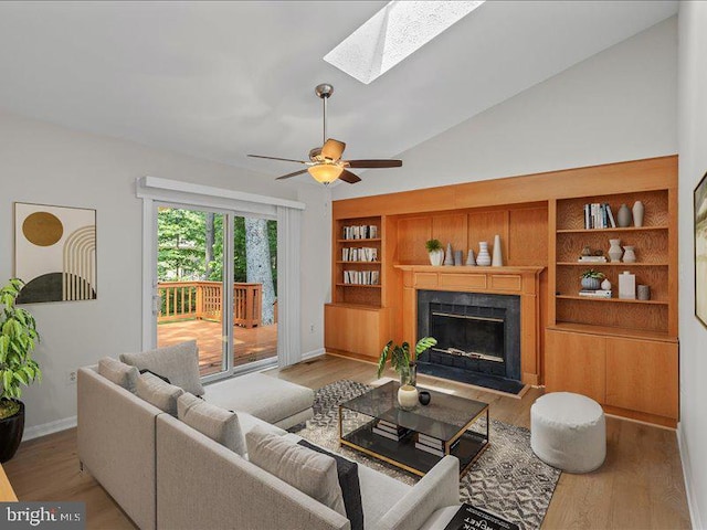 900 Young Dairy Ct, Herndon, VA 20170 - living area with vaulted ceiling, wood finished floors, a skylight, a premium fireplace, and built in shelves