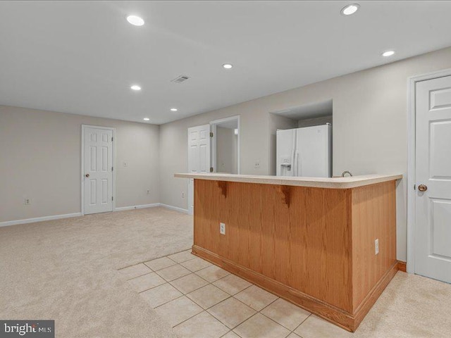 900 Young Dairy Ct, Herndon, VA 20170 - kitchen featuring white refrigerator with ice dispenser, recessed lighting, a breakfast bar area, light countertops, and light carpet
