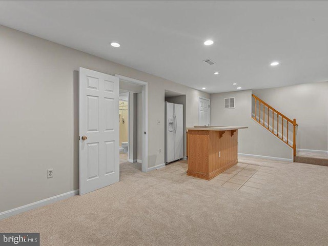 900 Young Dairy Ct, Herndon, VA 20170 - kitchen with white fridge with ice dispenser, light carpet, a center island, recessed lighting, and a kitchen breakfast bar