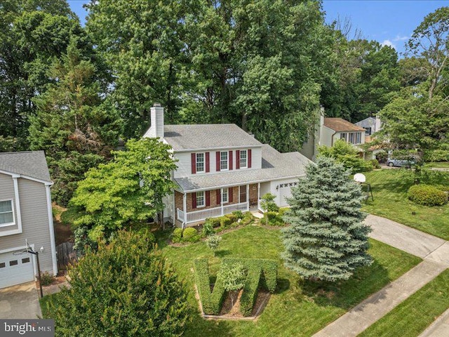 900 Young Dairy Ct, Herndon, VA 20170 - view of front of property with a porch, a chimney, an attached garage, a front lawn, and a shingled roof