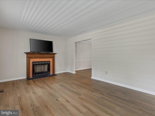 900 Young Dairy Ct, Herndon, VA 20170 - unfurnished living room featuring wood finished floors and a fireplace