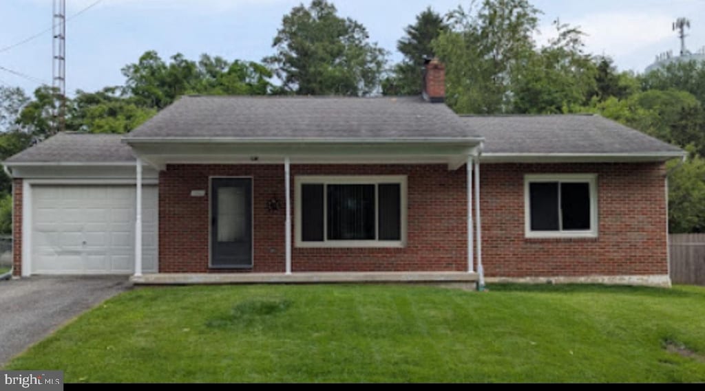 1116 2nd Ave, Brunswick, MD 21716 - ranch-style home with a garage, brick siding, a chimney, and asphalt driveway