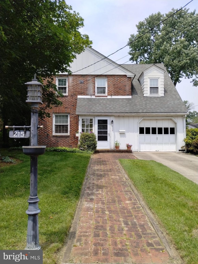 215 N Vineyard Blvd, Collingswood, NJ 08108 - view of front of home with a garage, concrete driveway, a front yard, roof with shingles, and brick siding