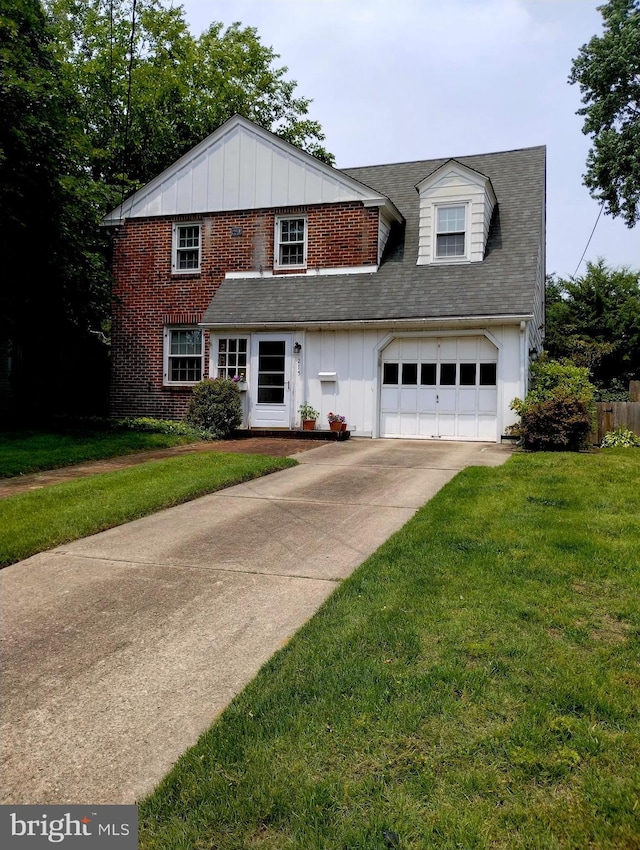 215 N Vineyard Blvd, Collingswood, NJ 08108 - view of front of house featuring board and batten siding, driveway, a front lawn, an attached garage, and brick siding