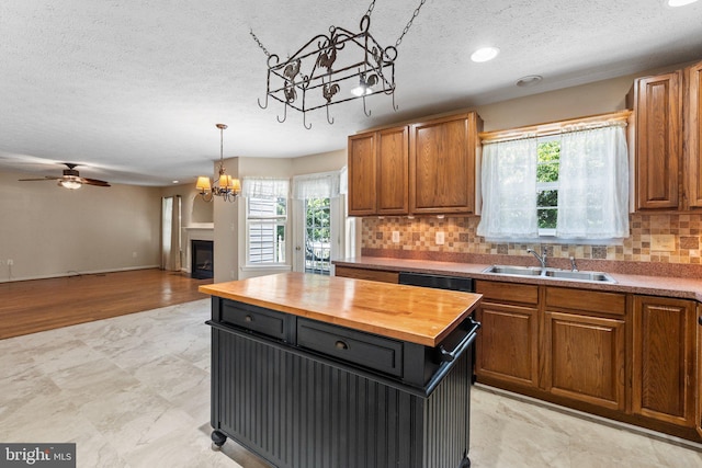 135 Hobbs Hole Ln, Tappahannock, VA 22560 - kitchen featuring wooden counters, a chandelier, a textured ceiling, plenty of natural light, and tasteful backsplash