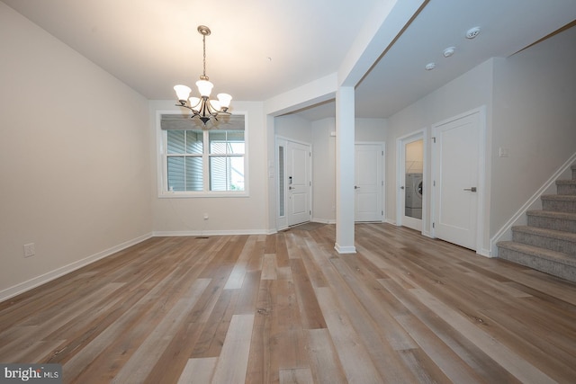726 Switchman Rd, Media, PA 19063 - entrance foyer featuring a chandelier, stairway, light wood-style flooring, and washer / dryer