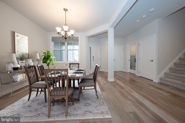 726 Switchman Rd, Media, PA 19063 - dining room featuring a chandelier, stairway, light wood finished floors, and washer / clothes dryer