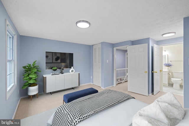 8318 Brookvale Ct, Springfield, VA 22153 - bedroom with carpet, multiple windows, a textured ceiling, and ensuite bath