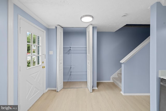 8318 Brookvale Ct, Springfield, VA 22153 - foyer featuring light wood-style floors, a textured ceiling, and stairs