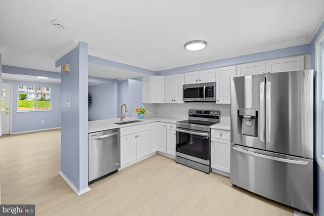 8318 Brookvale Ct, Springfield, VA 22153 - kitchen with stainless steel appliances, light wood-style floors, light countertops, a textured ceiling, and white cabinets