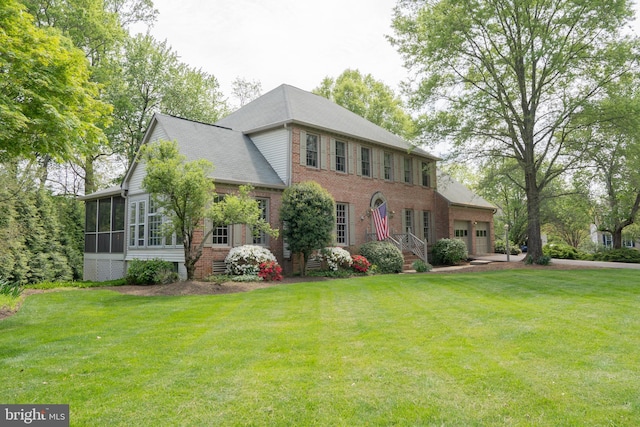 3259 Chrisland Dr, Annapolis, MD 21403 - colonial home featuring an attached garage, brick siding, a sunroom, and a front lawn