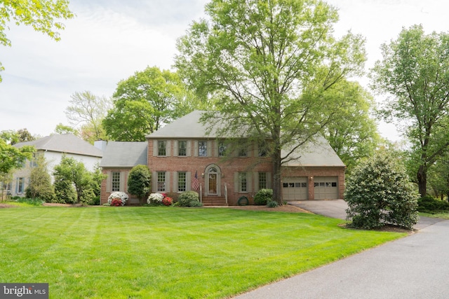 3259 Chrisland Dr, Annapolis, MD 21403 - colonial home featuring brick siding, a front lawn, a garage, and driveway
