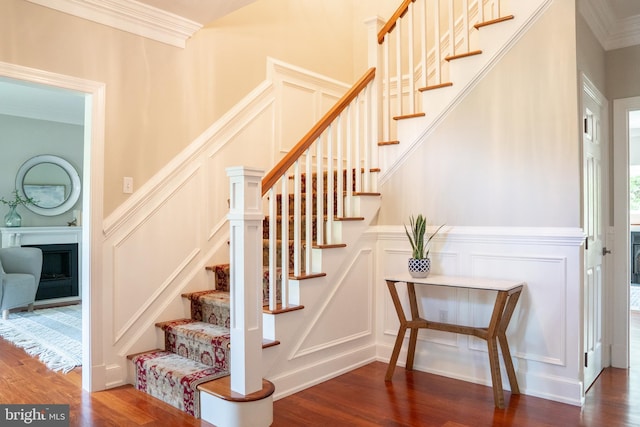 3259 Chrisland Dr, Annapolis, MD 21403 - staircase featuring a decorative wall, wood finished floors, ornamental molding, a fireplace, and a wainscoted wall