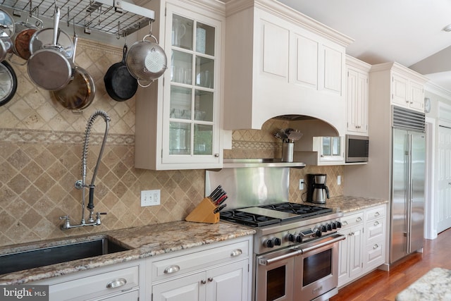 3259 Chrisland Dr, Annapolis, MD 21403 - kitchen with high quality appliances, glass insert cabinets, light wood-style flooring, and light stone countertops