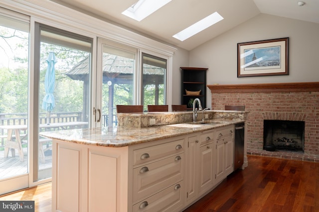 3259 Chrisland Dr, Annapolis, MD 21403 - kitchen with a skylight, wood finished floors, dishwasher, light stone countertops, and lofted ceiling