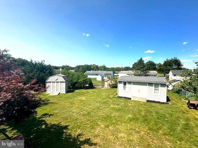 32 Saranac Rd, Hamilton, NJ 08619 - view of green lawn with a storage unit