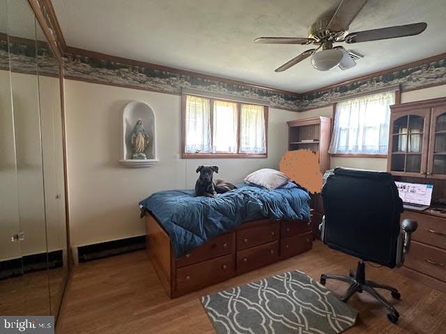 32 Saranac Rd, Hamilton, NJ 08619 - bedroom with wood finished floors, ceiling fan, and a desk