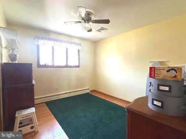 32 Saranac Rd, Hamilton, NJ 08619 - unfurnished office with a baseboard radiator, ceiling fan, and wood finished floors