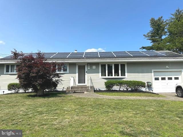 32 Saranac Rd, Hamilton, NJ 08619 - ranch-style home with solar panels, a front yard, an attached garage, and entry steps