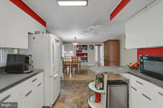 1134 William St, State College, PA 16801 - kitchen featuring black microwave, ceiling fan, stone finish floors, white cabinets, and a textured ceiling