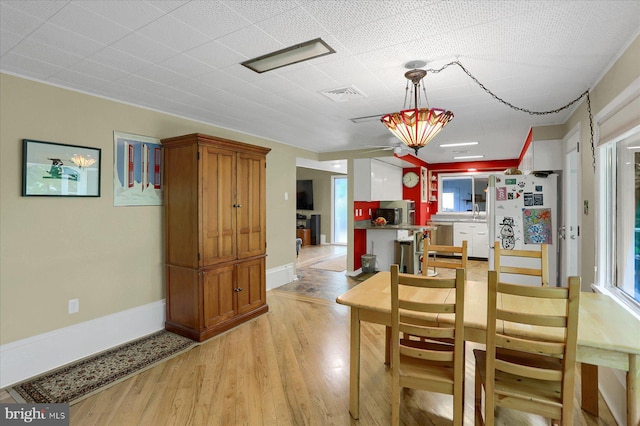 1134 William St, State College, PA 16801 - dining room with light wood-style flooring and baseboards